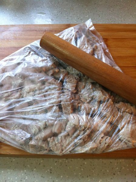 面包机自制肉松的做法操作步骤第3步：取出的肉块沥干水份，放入保鲜袋中，用擀面杖敲散。（肉趁热敲很容易敲散，不要等凉透了再敲）