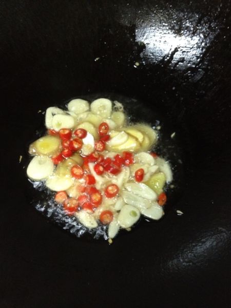 香辣姜葱爆炒花甲的做法操作步骤第4步：热锅烧油放入姜蒜指天椒末爆香。