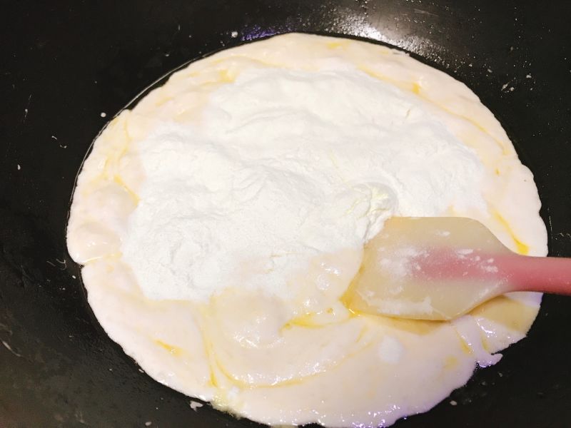 雪花酥的做法操作步骤第5步：放入奶粉搅拌 可以放抹茶奶粉还可以加可可奶粉等