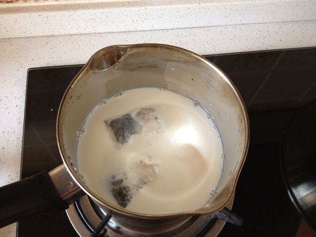 自制丝袜奶茶的做法操作步骤第3步：将茶包放在牛奶里一起煮，并加入糖，注意搅拌。小火慢煮，不要煮沸。红茶渗透即可关火