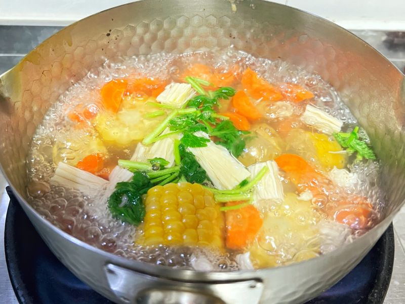 玉米腐竹汤的做法操作步骤第3步：煮开，放入腐竹和香菜。