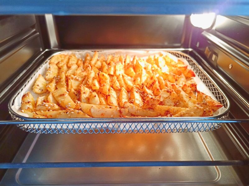 夏日小吃烤薯角的做法操作步骤第8步：当当当！无油版烤薯角就出炉了。
