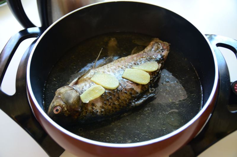 鲫鱼山药汤的做法操作步骤第2步：两面都煎过后，加入热水。