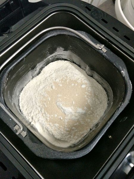 黄油面包的做法操作步骤第1步：依次把清水、鸡蛋、白糖、盐、低筋面粉、高筋面粉、酵母放入面包桶里。