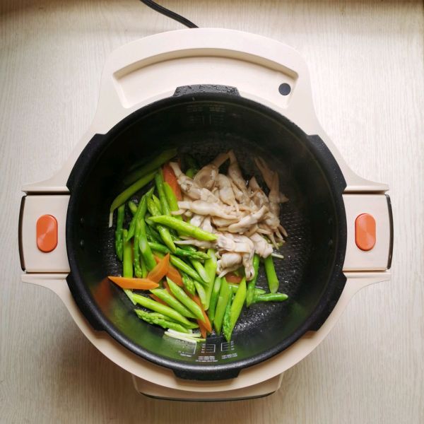 芦笋炒蛏子的做法操作步骤第5步：下芦笋、胡萝卜片、蛏子肉翻炒1分钟